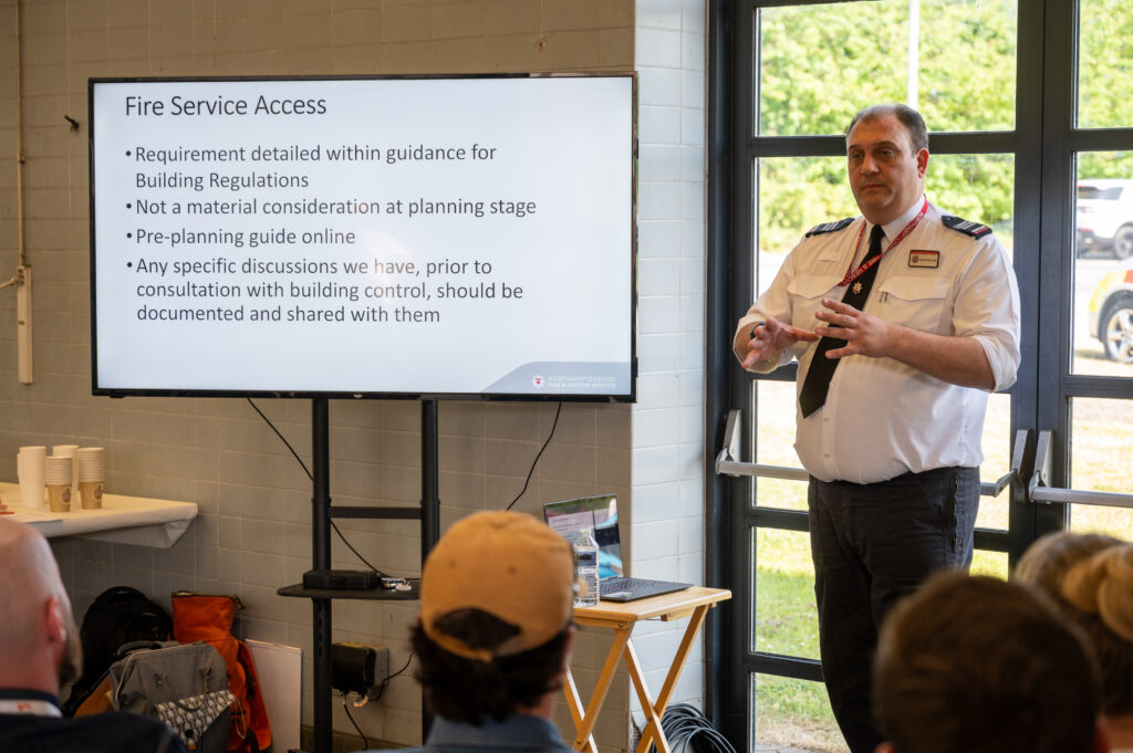 A member of fire staff in a white shirt delivering a presentation