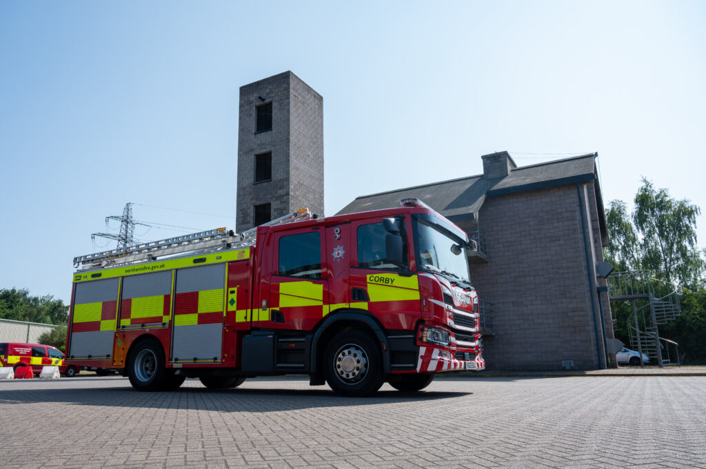 A fire engine parked outside a fire station
