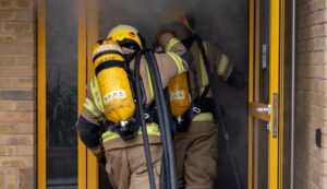 Image of two firefighters in BA walking into a building